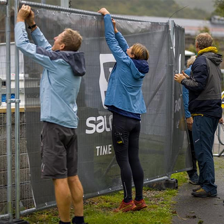 Event Organisers hanging Fence Banners