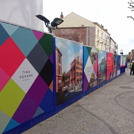 Printed hoarding boards on building site perimeter