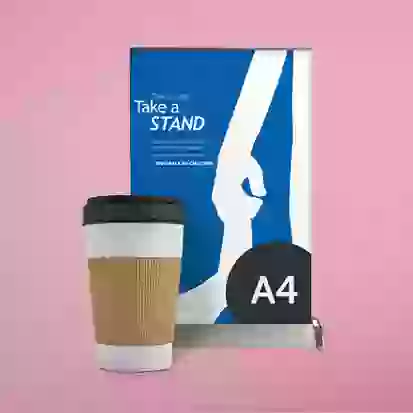 A4 desktop roller banner next to coffee mug