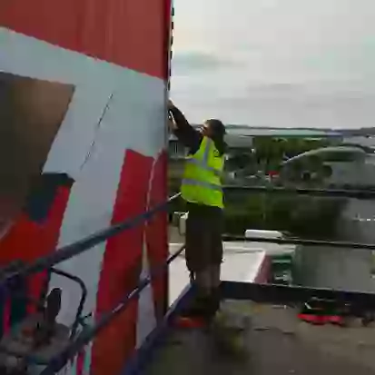 Team member installing building wrap at Stoke City FC