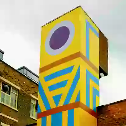 Brightly coloured building wrap on section of building
