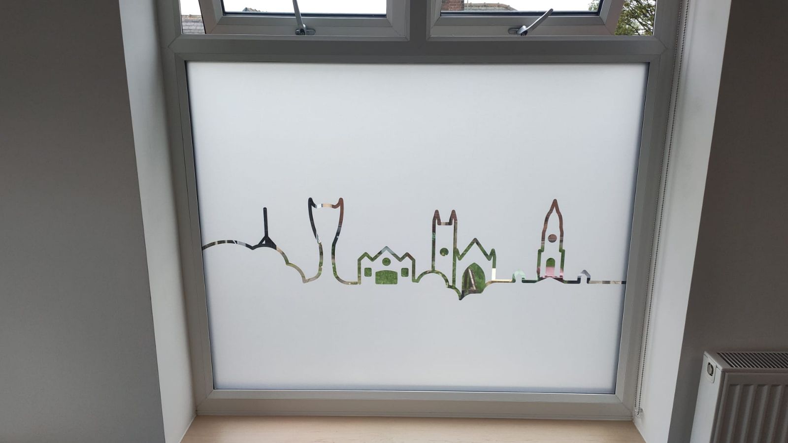 Frosted vinyl cityscape outline applied to lower window pane