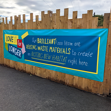 PVC Banner Attached to Wooden Fence